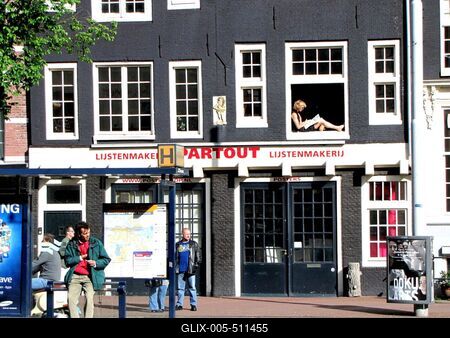 Sunbathing Man in a Window of Amsterdam-stock-foto