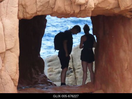 Tourists on the rocky beach of Arbatax - Wndow in the rock - Sardinia - Italy-stock-foto
