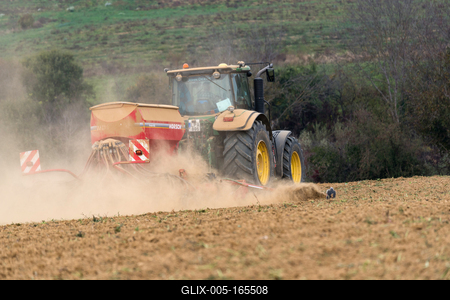 A farmer sowing with a John Deere tractor and a Horsch Pronto 4dc seeding machine.-stock-foto