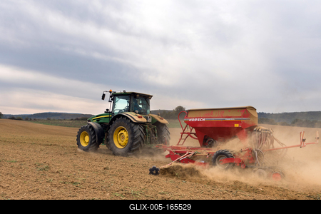 A farmer sowing with a John Deere tractor and a Horsch Pronto 4dc seeding machine.-stock-foto
