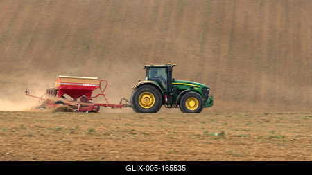 A farmer sowing with a John Deere tractor and a Horsch Pronto 4dc seeding machine. It's a panning shot, that cause the blurry background.-stock-foto