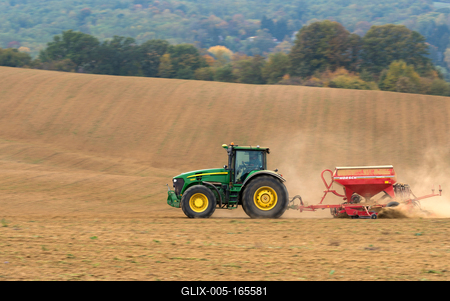 A farmer sowing with a John Deere tractor and a Horsch Pronto 4dc seeding machine. It's a panning shot, that cause the blurry background.-stock-foto