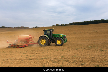 A farmer sowing with a John Deere tractor and a Horsch Pronto 4dc seeding machine. It's a panning shot, that cause the blurry background.-stock-foto