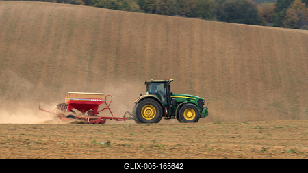 A farmer sowing with a John Deere tractor and a Horsch Pronto 4dc seeding machine. It's a panning shot, that cause the blurry background.-stock-foto