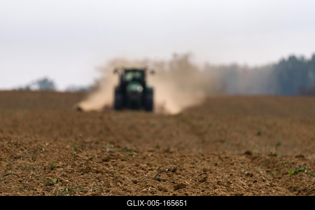 A farmer sowing in the background with a John Deere tractor and a Horsch Pronto 4dc seeding machine.-stock-foto