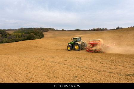 A farmer sowing with a John Deere tractor and a Horsch Pronto 4dc seeding machine. It's a panning shot, that cause the blurry background.-stock-foto