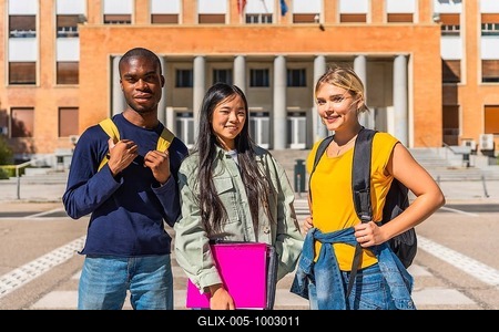 Portrait of three multi-ethnic students at the campus standing outside the entrance of the university-stock-foto