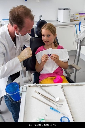 Dentist discussing further treatment with a girl and showing her braces, Germany-stock-foto