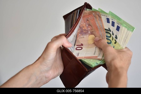 Hands holding many euro banknotes in a leather wallet, symbolising wealth, cash, saving or waste-stock-foto