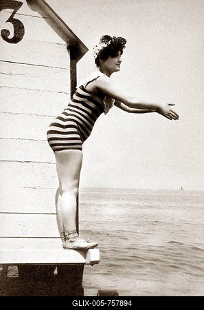 Woman in striped swimsuit wants to jump into the water, 1910s, Baltic Sea, Germany-stock-foto