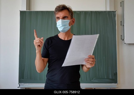 Teacher with face mask in face-to-face teaching, gestures, corona crisis, Stuttgart, Baden-Württemberg, Germany-stock-foto