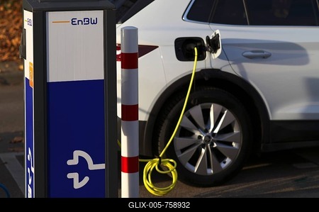 Parking lot with gas pump, EnBW charging station for electric cars, charging station, e-charging station, e-mobility, charging cable leading into a vehicle, e-car, pictogram, logo, Stuttgart, Baden-Württemberg, Germany-stock-foto