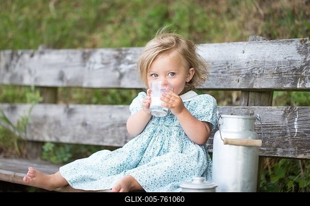 Girl drinking milk on a bench at an Alpine hut, Germany-stock-foto