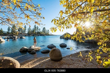 Young woman in bikini standing on a round stone in the water, bay at lake Lake Tahoe, Sand Harbor State Park, shore, California, USA-stock-foto