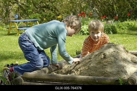 Two boys seven and nine year old playing in the sandbox-stock-foto