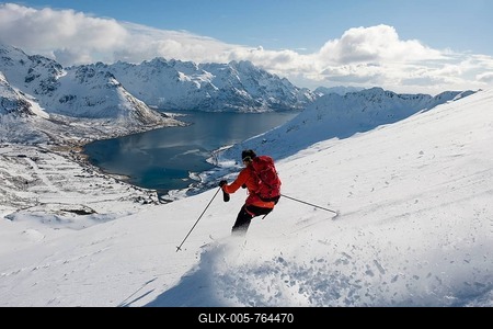 Skier descending from Pilan overlooking a fjord, Austvågøy, Lofoten, Norway-stock-foto