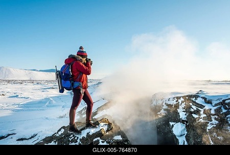 Woman standing at divergent tectonic boundary between North American and Eurasian plates, photographing, Mid-Atlantic Ridge, rift valley, Krafla, Mývatn, Northern Region, Iceland-stock-foto