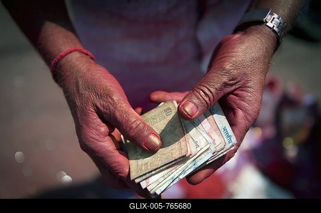 Indian rupees in the hands of a kum kum powder vendor, Calcutta, Kolkata, West Bengal, India, Asia-stock-foto