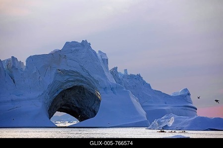 Kayaks in front of huge iceberg with cave, midnight, summer, Ilulissat, Disko Bay, Greenland, Denmark-stock-foto