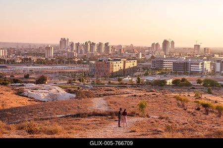 Evening atmosphere, Two people on a path, view of skyscrapers of Be'er Scheva, Israel-stock-foto