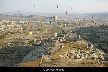 Hot air balloons rising over the cave dwellings and tufa formations in the morning light, Nevsehir Province, Cappadocia, Anatolia, Turkey-stock-foto