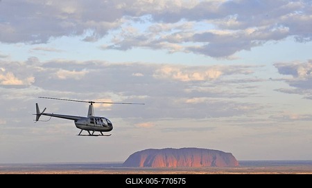 Aerial view of a helicopter in front of Uluru, Ayers Rock at sunset, Uluru-Kata Tjuta National Park, Northern Territory, Australia-stock-foto