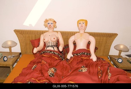 Blow-up sex dolls in a bed-stock-foto