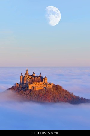 Burg Hohenzollern castle, with moon in morning light, autumn forest, morning mist, Schwaebische Alb, Swabian Alb, Baden-Wuerttemberg, Germany, Europe-stock-foto
