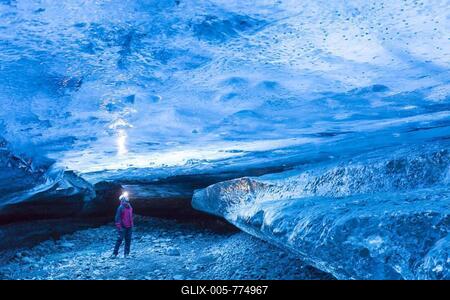 Tourist visiting The Crystal, natural ice cave in the Breiðamerkurjökull, Breidamerkurjokull Glacier in Vatnajökull National Park, Iceland-stock-foto