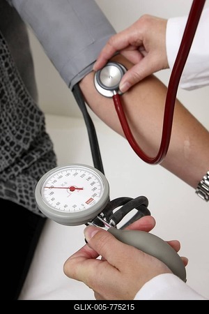 Medical practice, medical technician taking the blood pressure of a patient-stock-foto