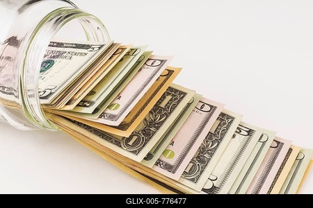 US paper currency bank notes in glass jar on white background, studio composition-stock-foto