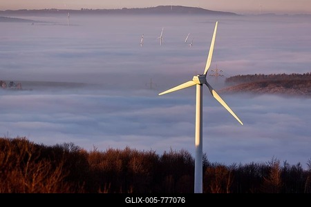 Wind turbine illuminated by the sun, forest rising from cloud cover, sunset, Köterberg, Lügde, Weserbergland, North Rhine-Westphalia, Germany-stock-foto