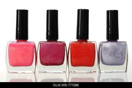 Four nail polish bottles in a row, different colors-stock-foto