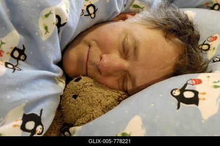 Man is sleeping with teddy bear-stock-foto