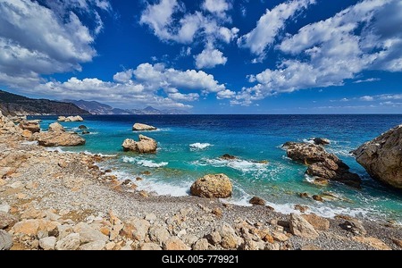 Stony coast with large rocks, turquoise blue sea and light cloud cover, Kato Lakkos Beach, still almost unspoilt bay, not accessible by car, Kato Lakkos, east coast, Karpathos, Dodecanese, Greek Islands, Greece-stock-foto