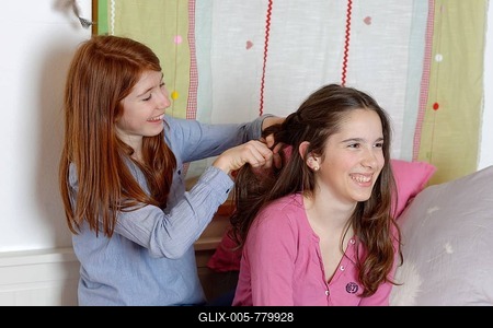 Teenage girls doing each other's hair, plaits, Germany-stock-foto