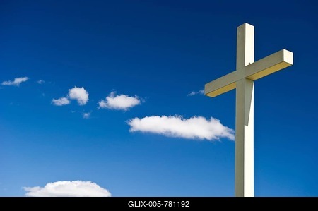 Cross against a blue sky with cumulus clouds-stock-foto