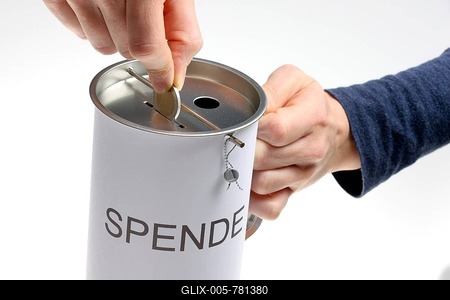 Hands with a donation box labeled Spende, German for donation, with slots for coins and bills, with a security seal to protect against unlawful opening-stock-foto
