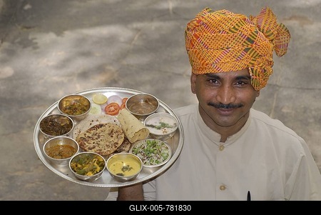 Rajasthani thali served on a silver tray, carried by waiter wearing a turban, Narain, Niwas Heritage Hotel, Jaipur, Rajasthan, North India, India, Asia-stock-foto