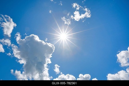 Sun star in blue sky with some source clouds in backlight, Switzerland-stock-foto
