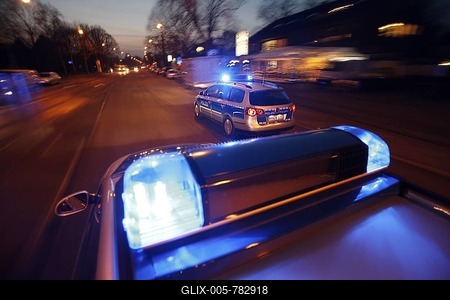 German police cars, blue design, in action with flashing sirens-stock-foto