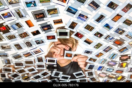 Young woman sorting mounted slides, slides are viewed with a magnifying glass or loupe-stock-foto