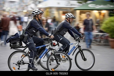 Bike police patrolling in a pedestrian zone, Germany, Europe-stock-foto