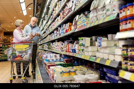 Senior couple shopping with a shopping trolley in the refrigerated dairy section in a supermarket, Germany-stock-foto
