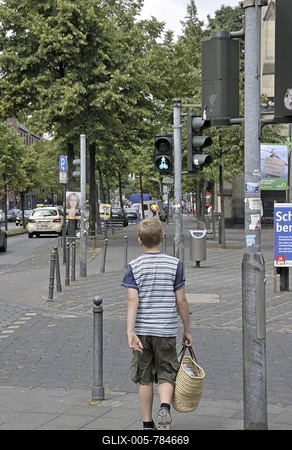 Nine-year-old boy crossing the street at green light, Germany, Europe-stock-foto