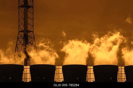 Smoke from chimneys at sunset at industrial estate showing BASF chemical production site in the port of Antwerp, Belgium-stock-foto