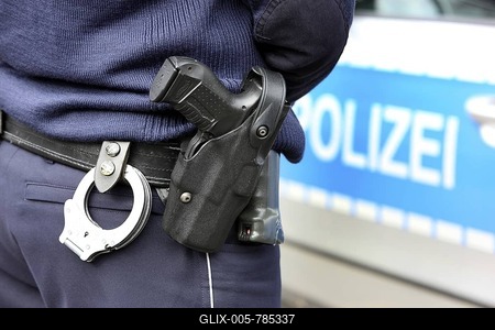 Police, police car, police officer with handcuffs and service weapon, Walther P99, in the holster-stock-foto