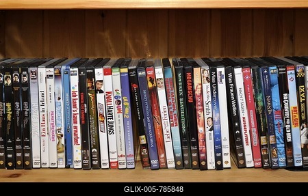 Various DVD movies on a shelf-stock-foto