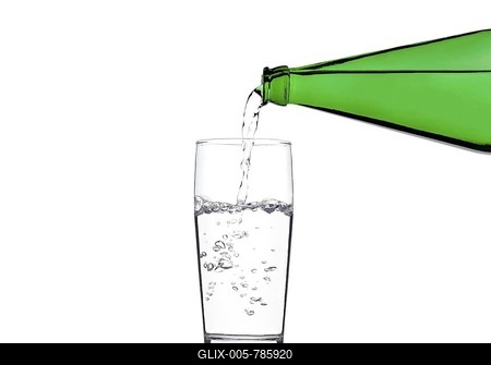 Pouring water from a green bottle into a glass-stock-foto