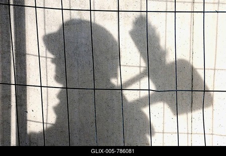 Shadow of a construction worker on a concrete wall, symbolic image for black labour, illegal employment, Germany-stock-foto